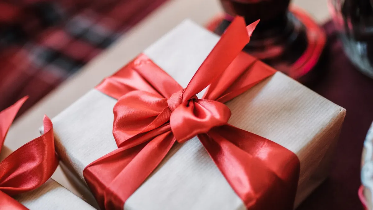Una scatola regalo con nastro rosso